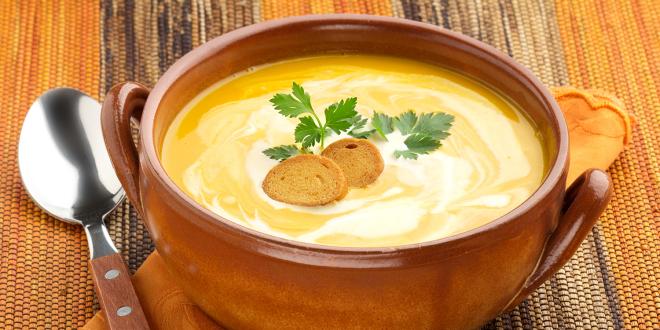 a bowl of carrot soup with a dollop of yogurt